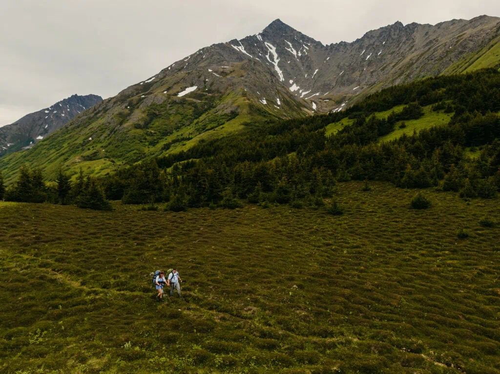A drone photo of the couple on the trial in the mountains.