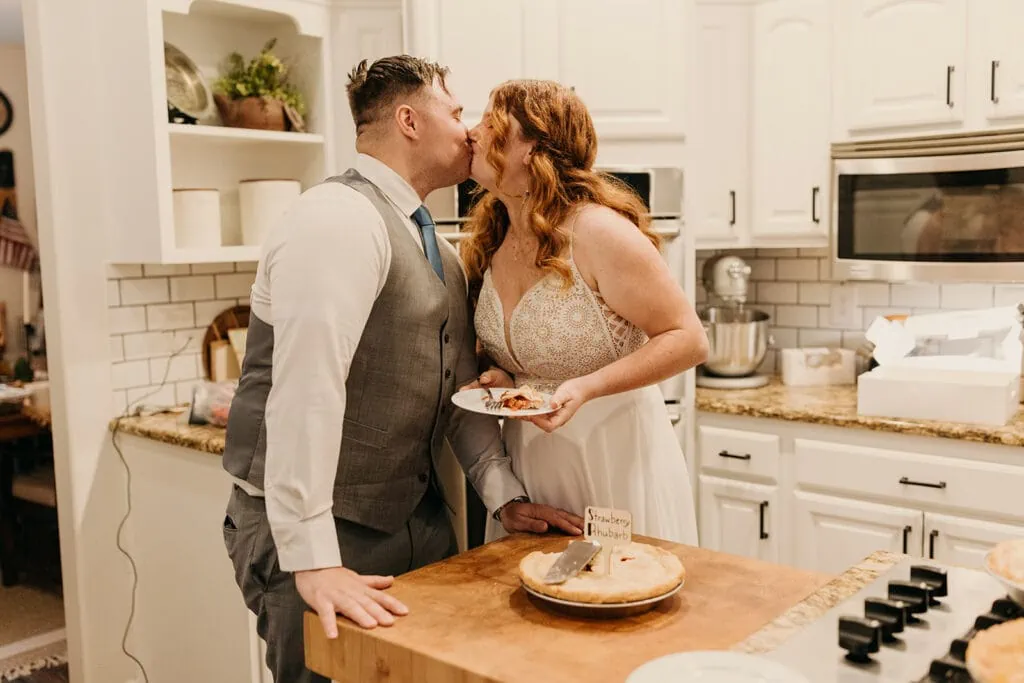 The couple shares a kiss in the kitchen over pie.