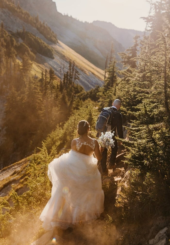 A couple hikes down the trail in Mt Rainier National Park on their wedding day.
