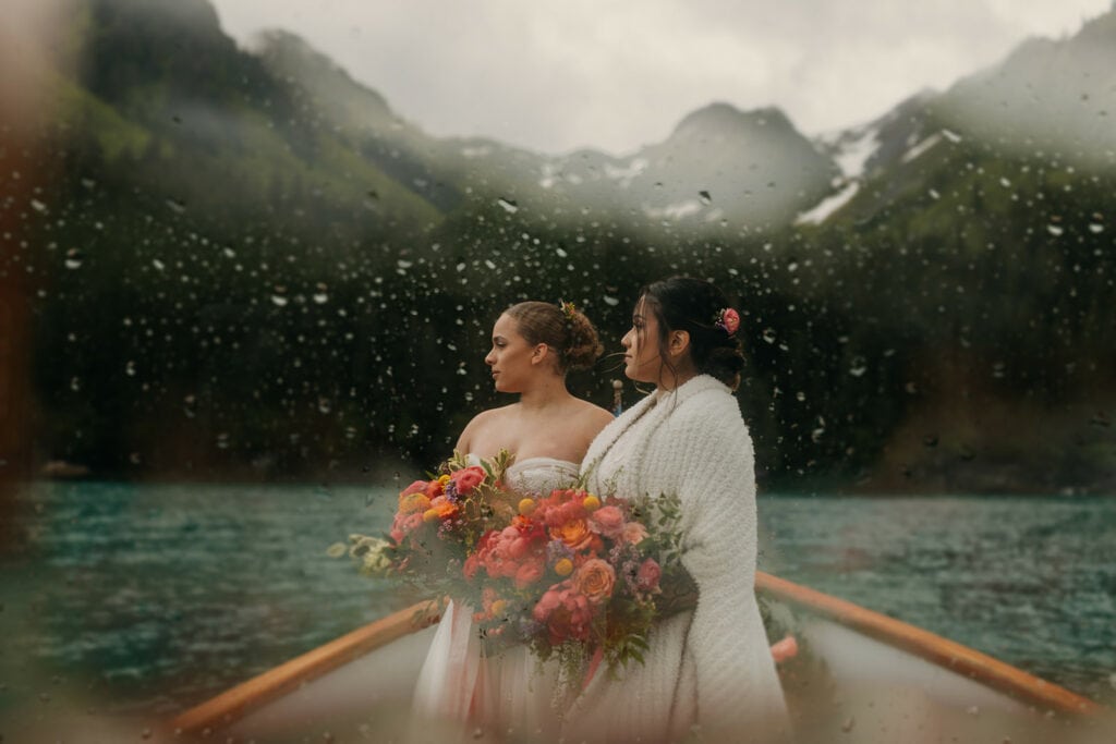 Two brides look at the view while on a boat tour in Seward Alaska.