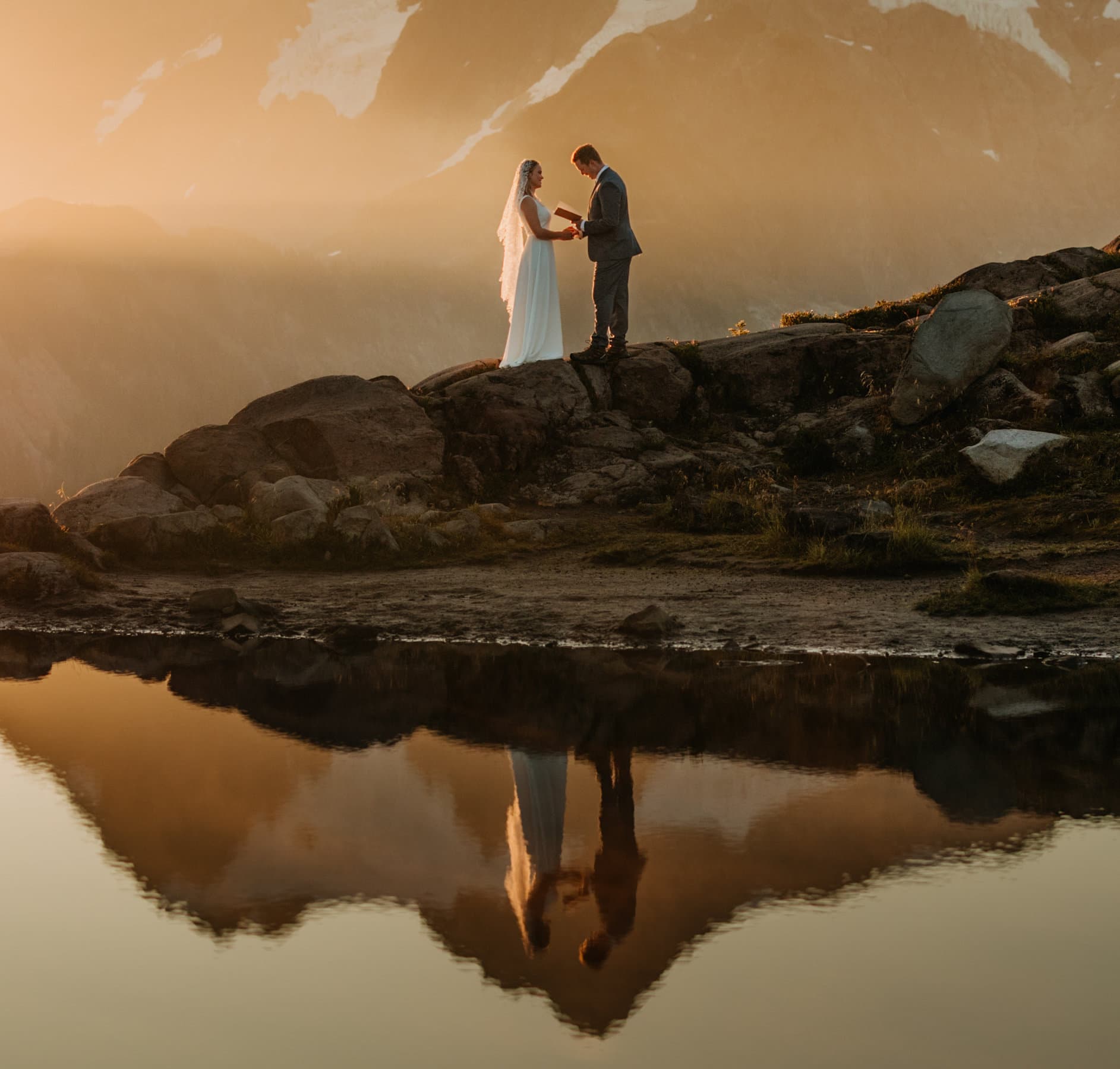 The couple shares private vows as the sun rises behind the mountain.