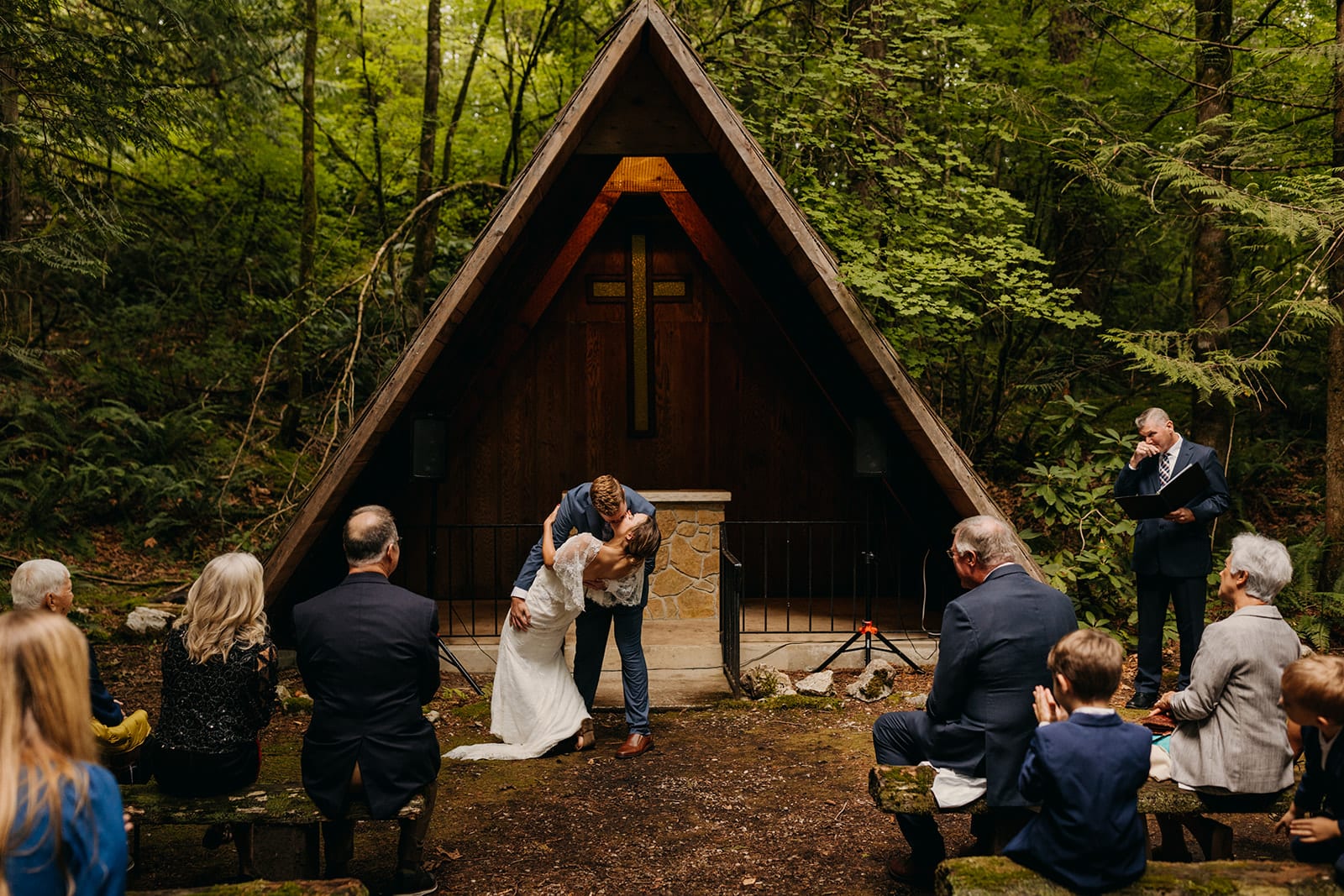 A couple shares their first kiss after getting married at Camp Saturna. 