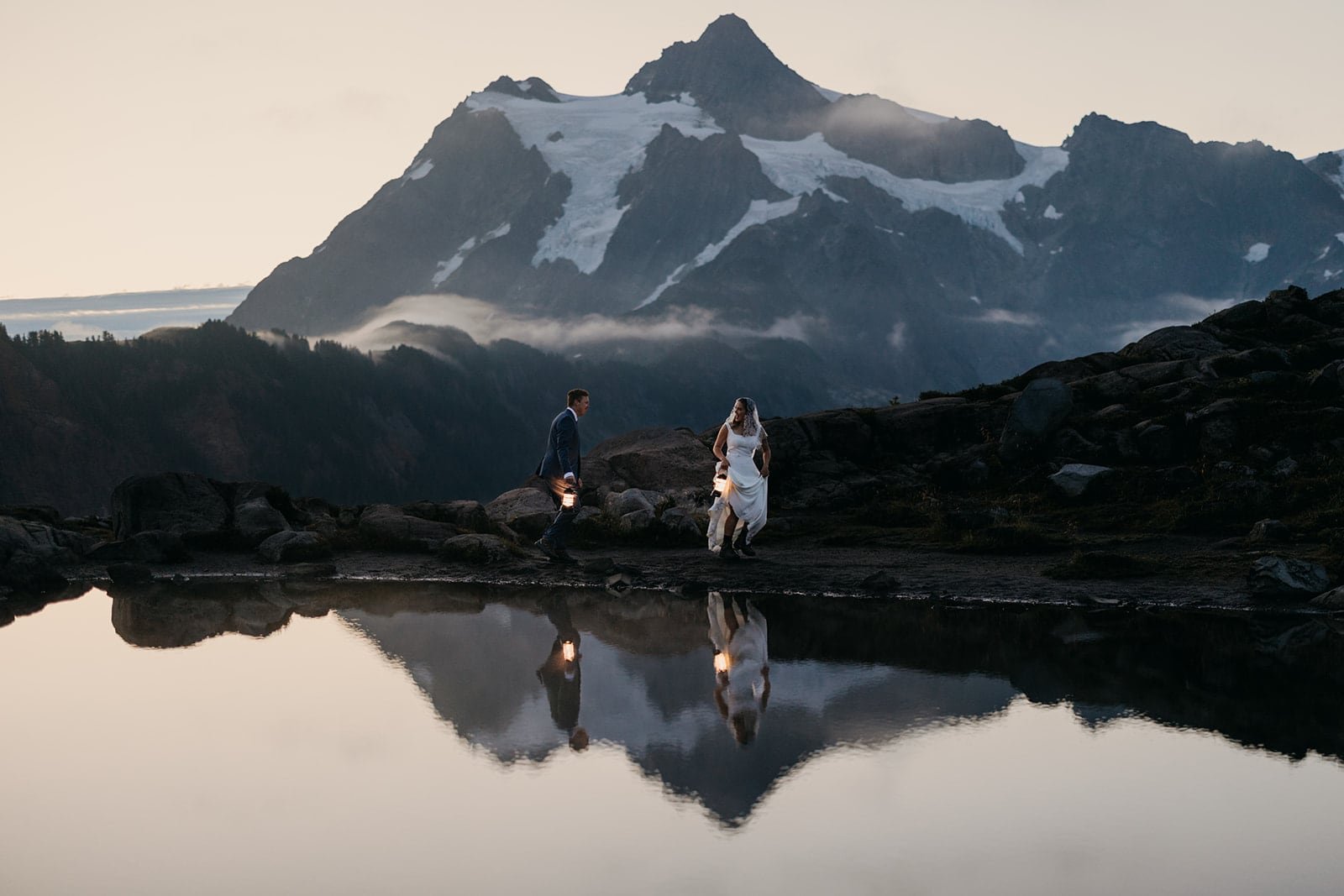 The couple walks around the mountains at sunrise.