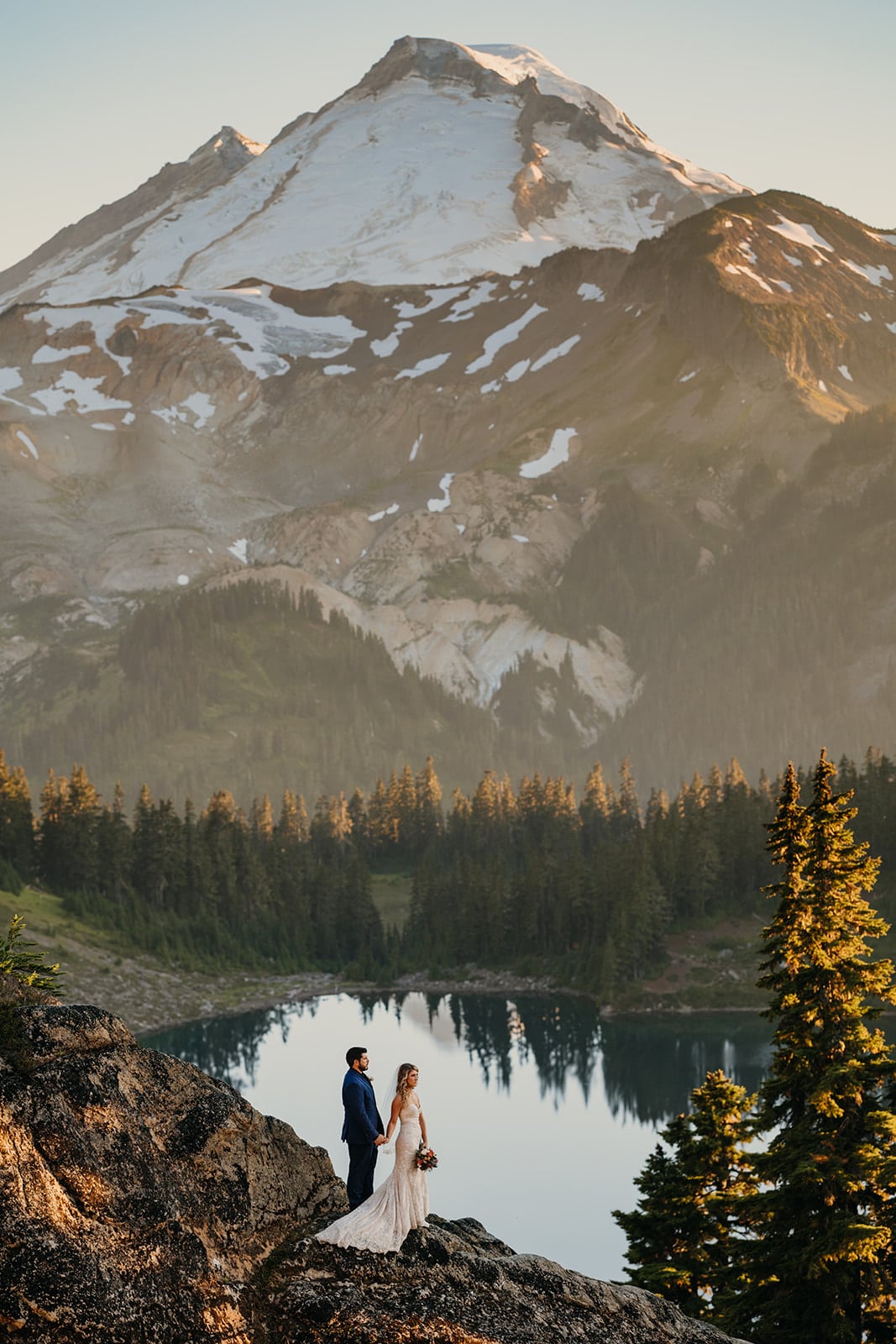 The couple stands for a portrait with Mt Baker.