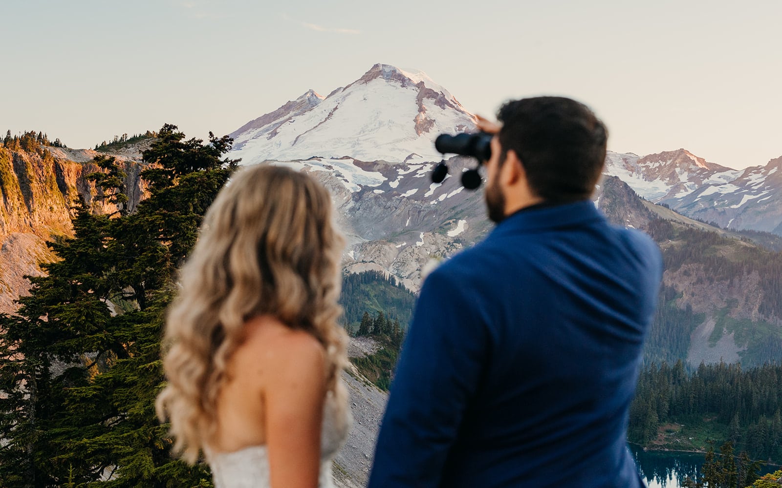The couple looks at the mountain.