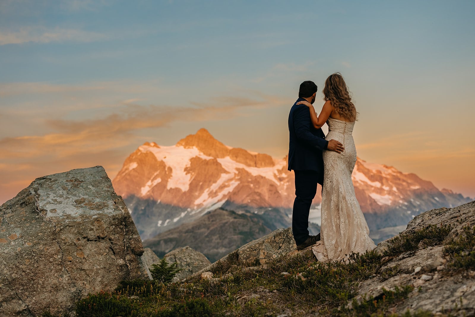The couple enjoys a colorful sunset in the mountains.