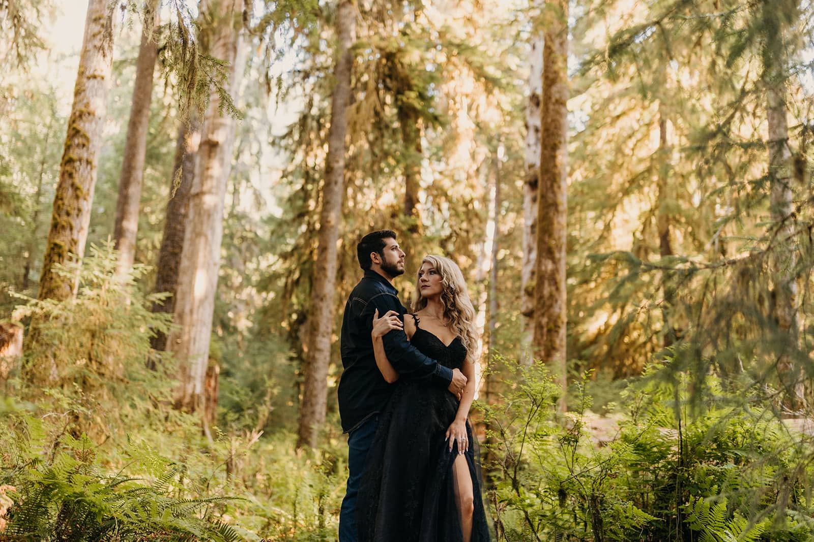 A photo of the couple in the trees. 