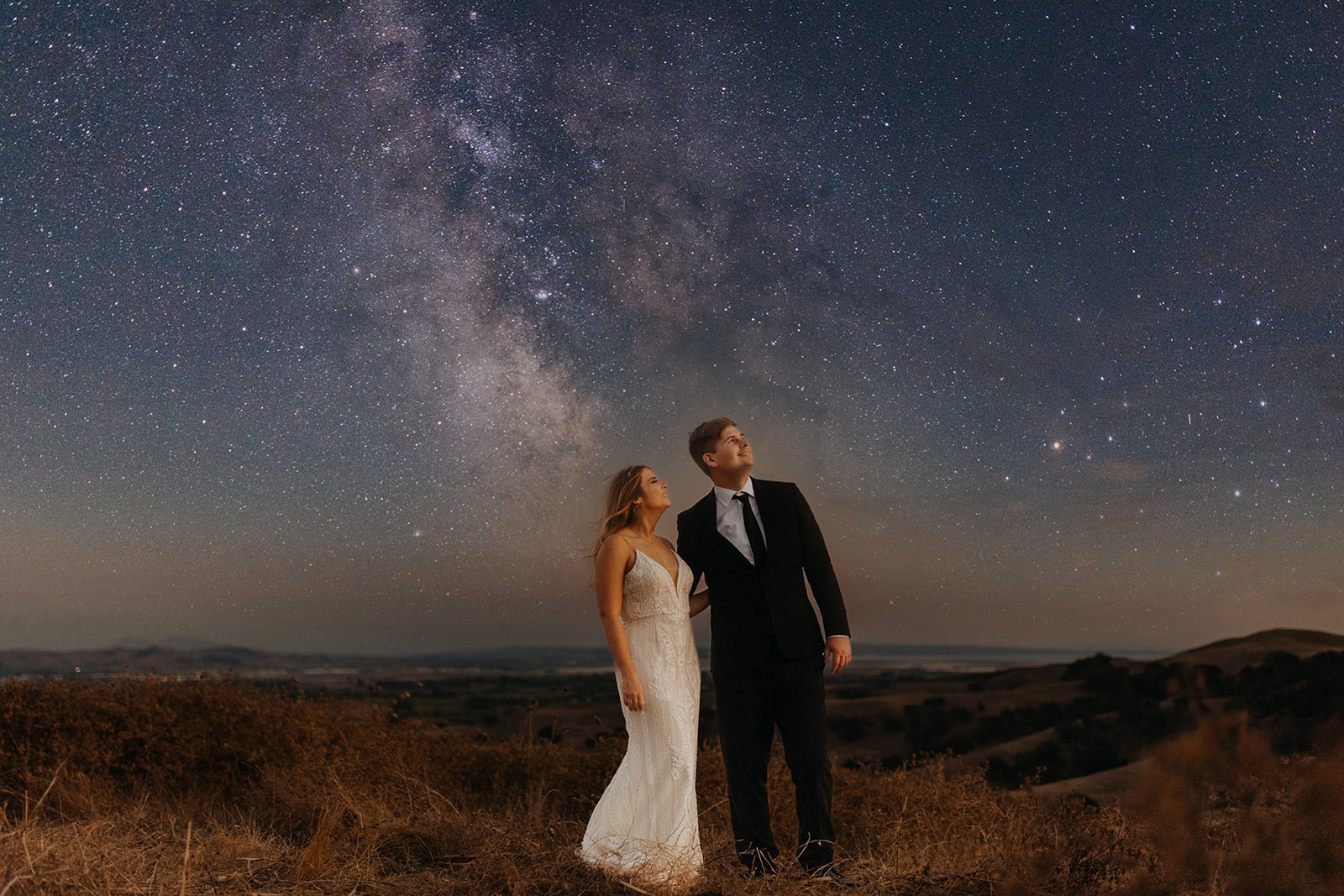 A couple admires the night sky.