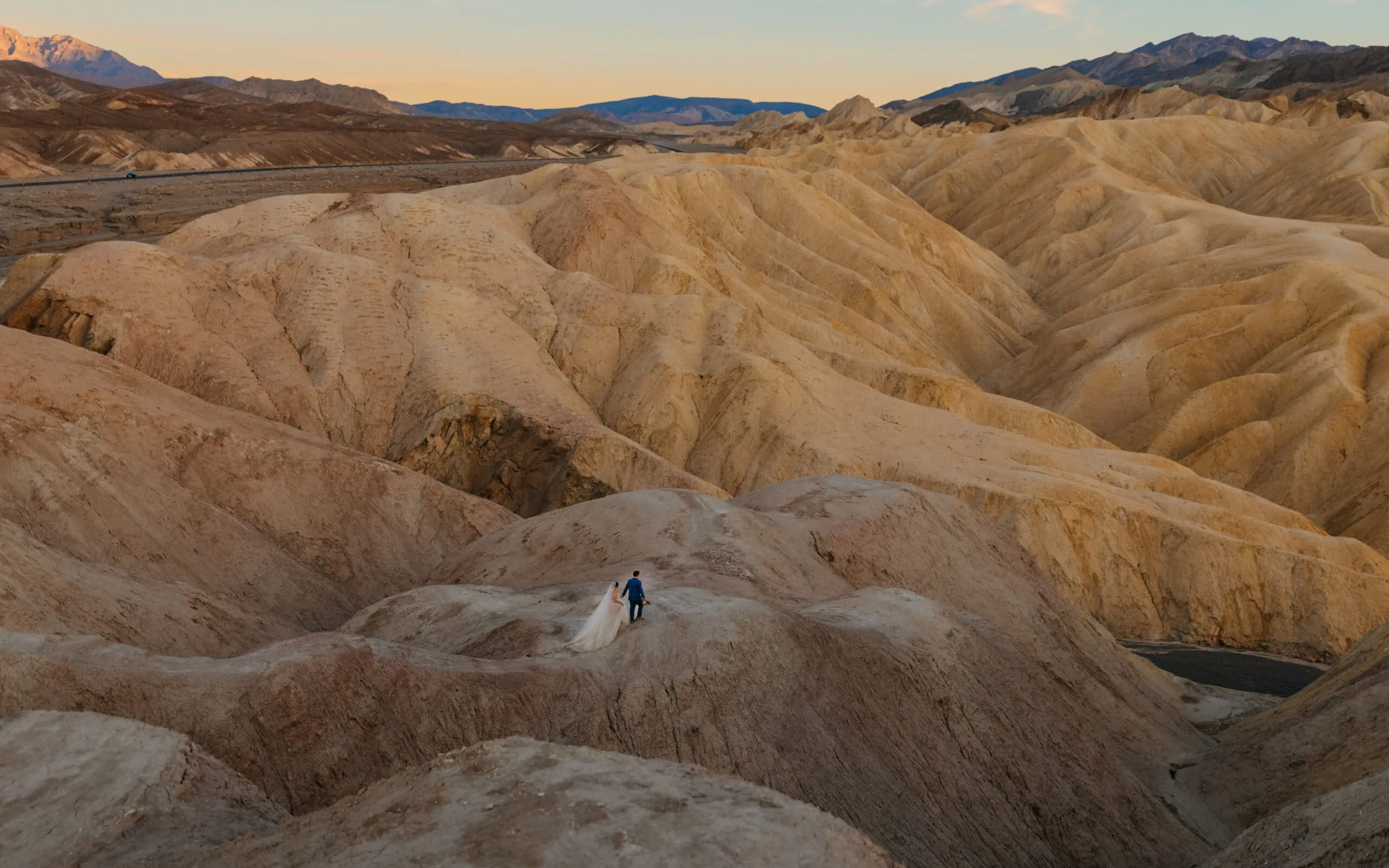 A couple explores Death Valley as the evening ends on their wedding day.
