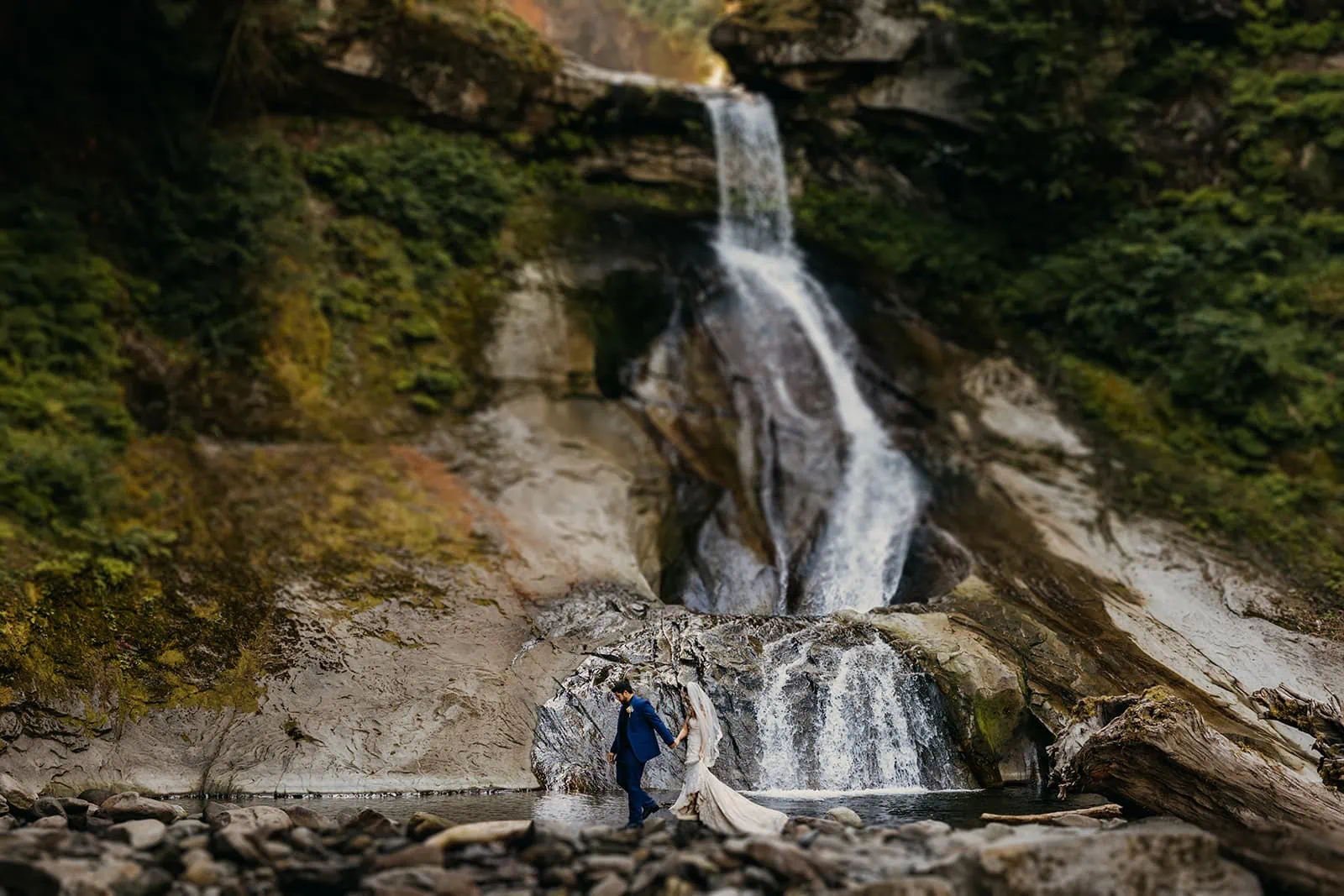 A couple explores the waterfalls after their first look.