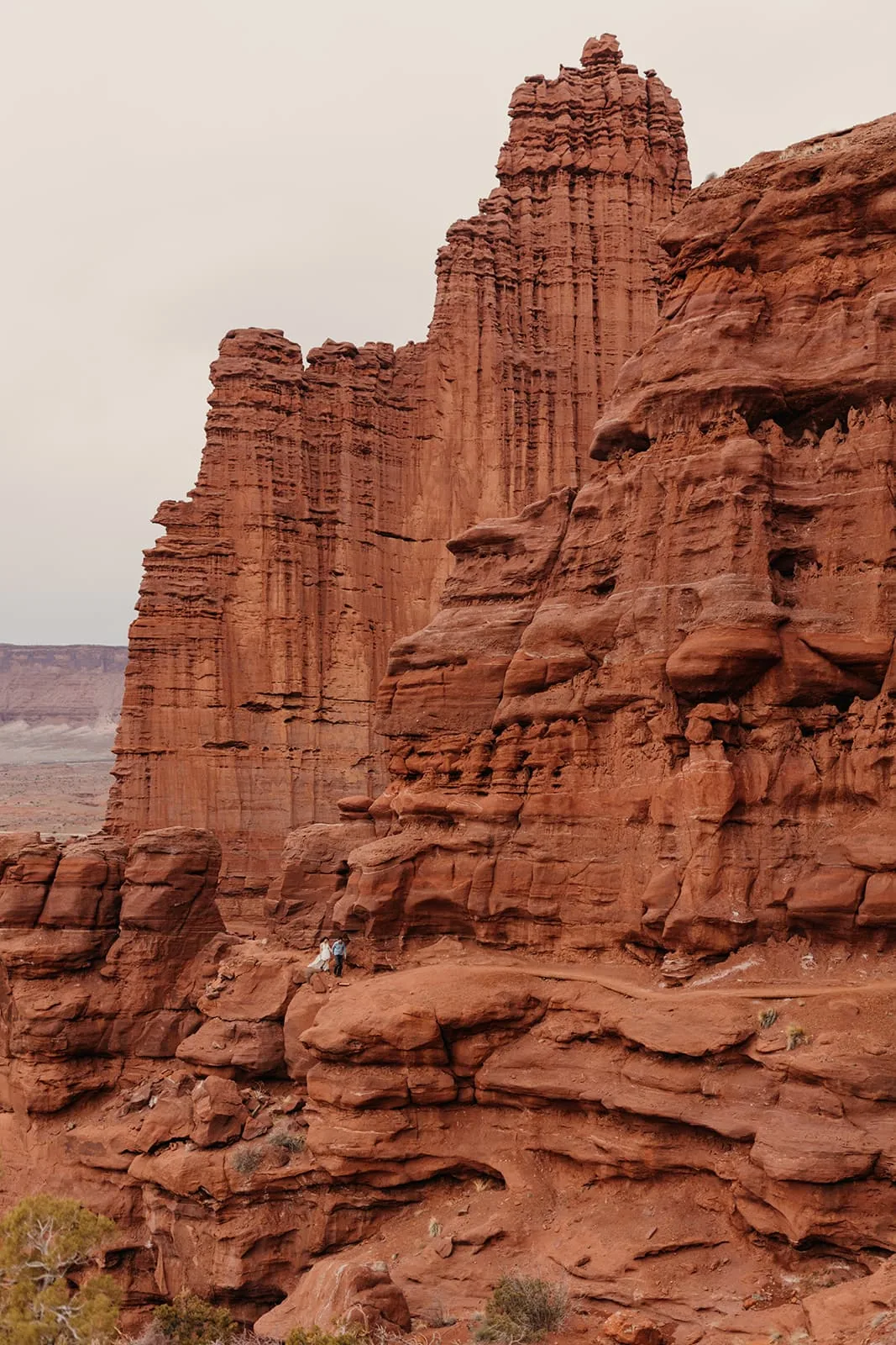 A couple walks together in the Fisher Towers area near Moab Utah