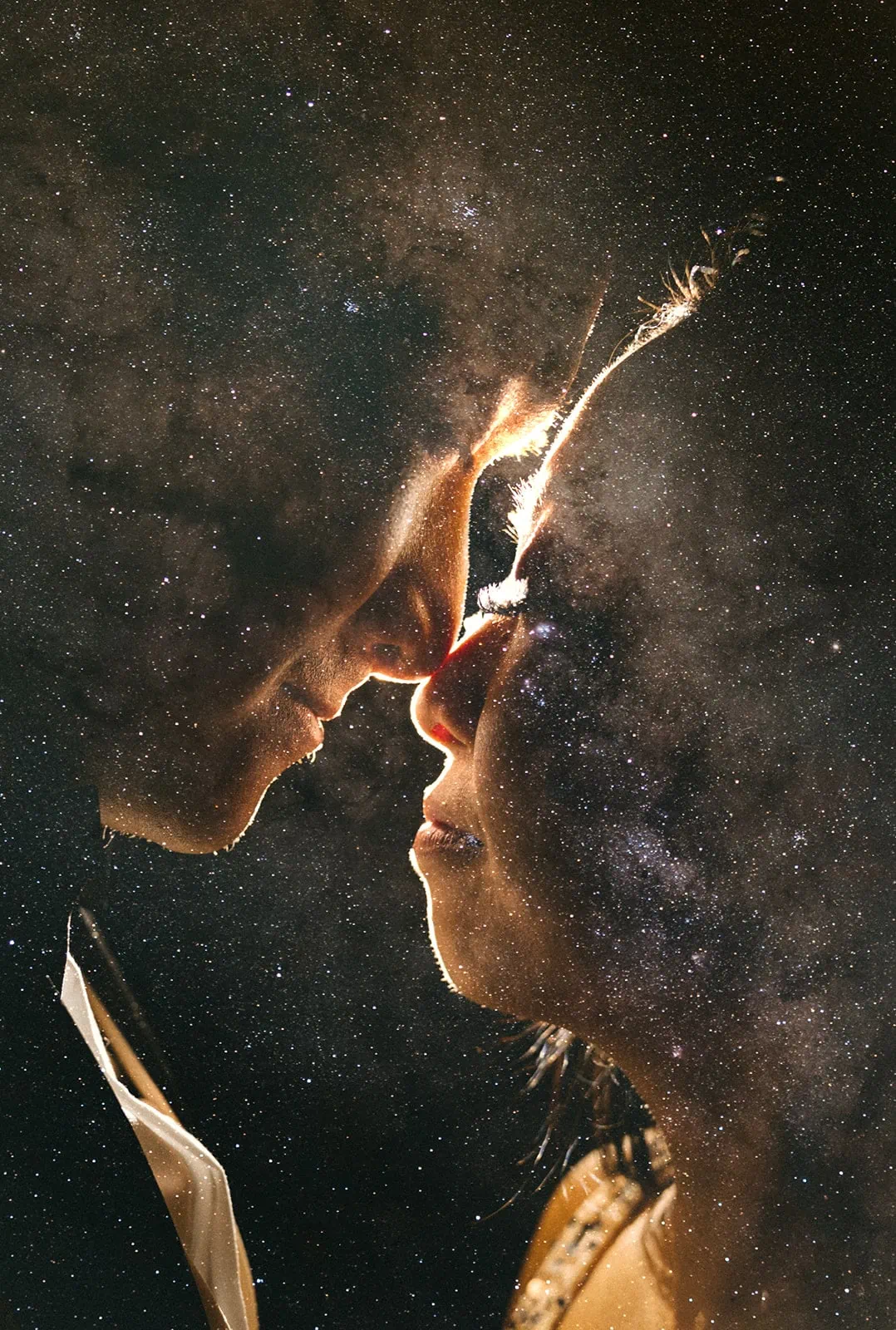 A double exposure of a close up portrait of a couple with their faces and the milkyway stars on top