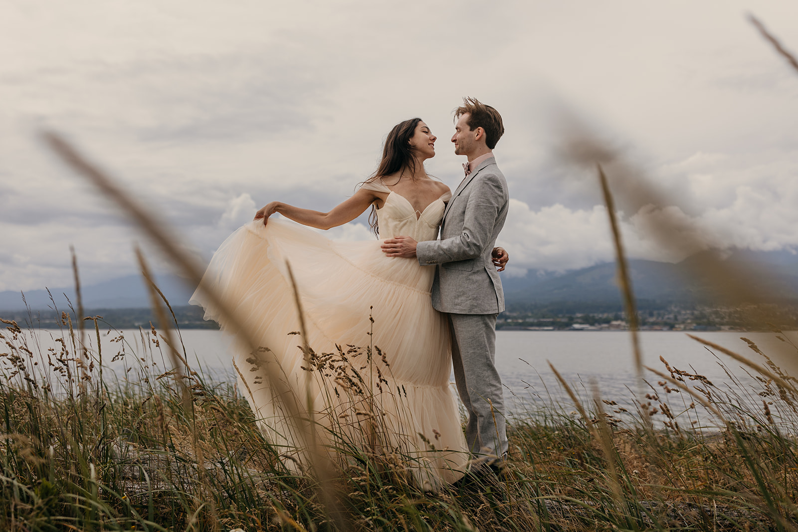A bride showcase the skirt of her yellow wedding dress.