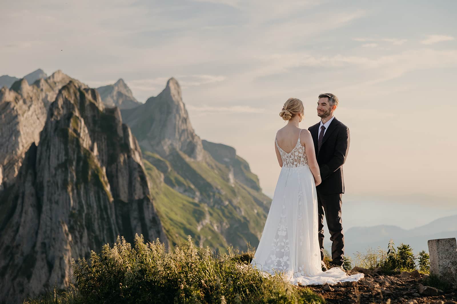 A groom smiles at his bride during their ceremony.
