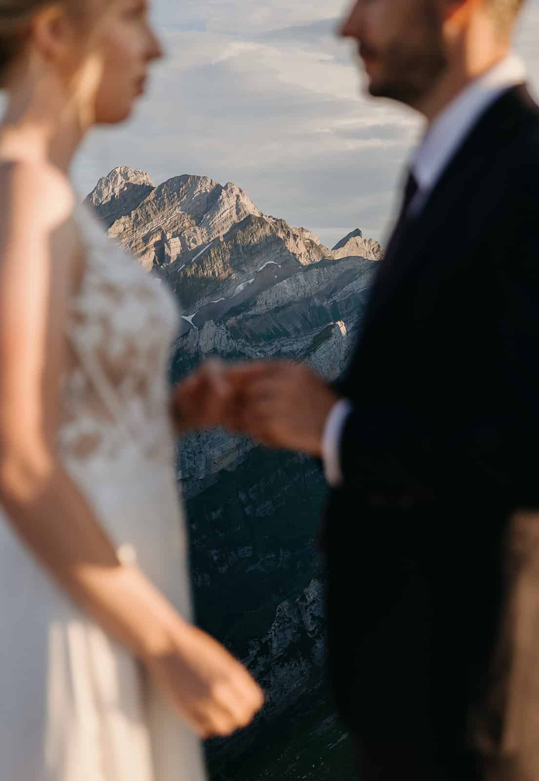 The groom places the ring on the brides finger.