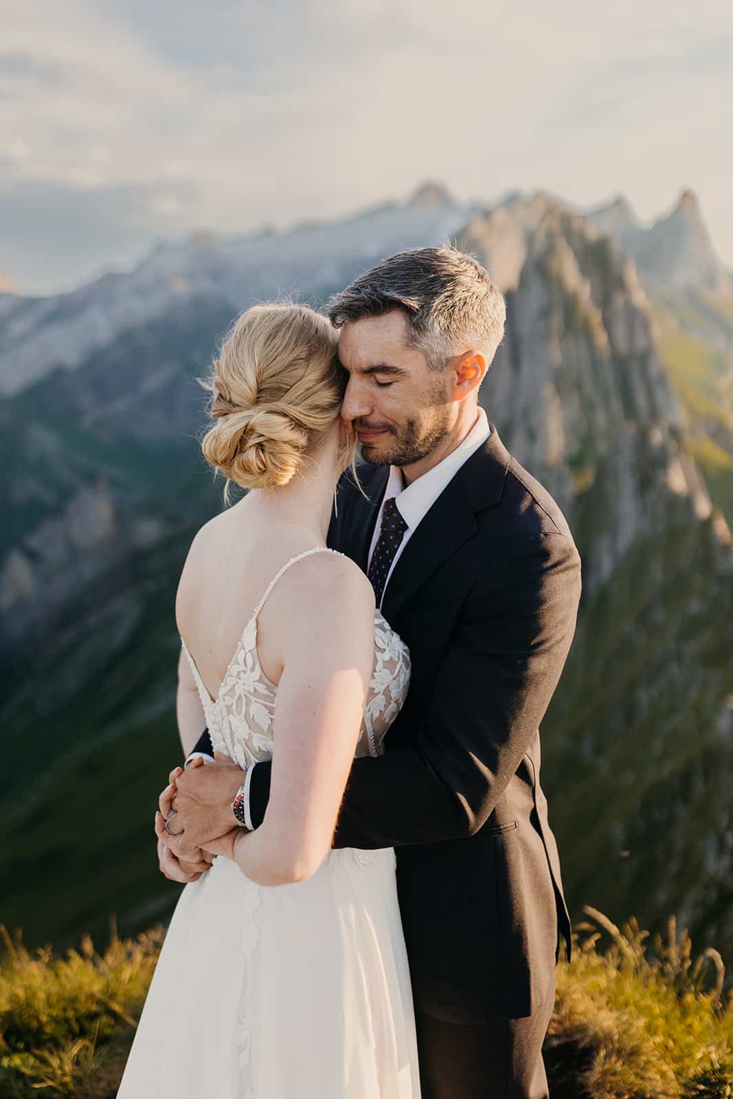 The groom holds his bride after their first kiss.