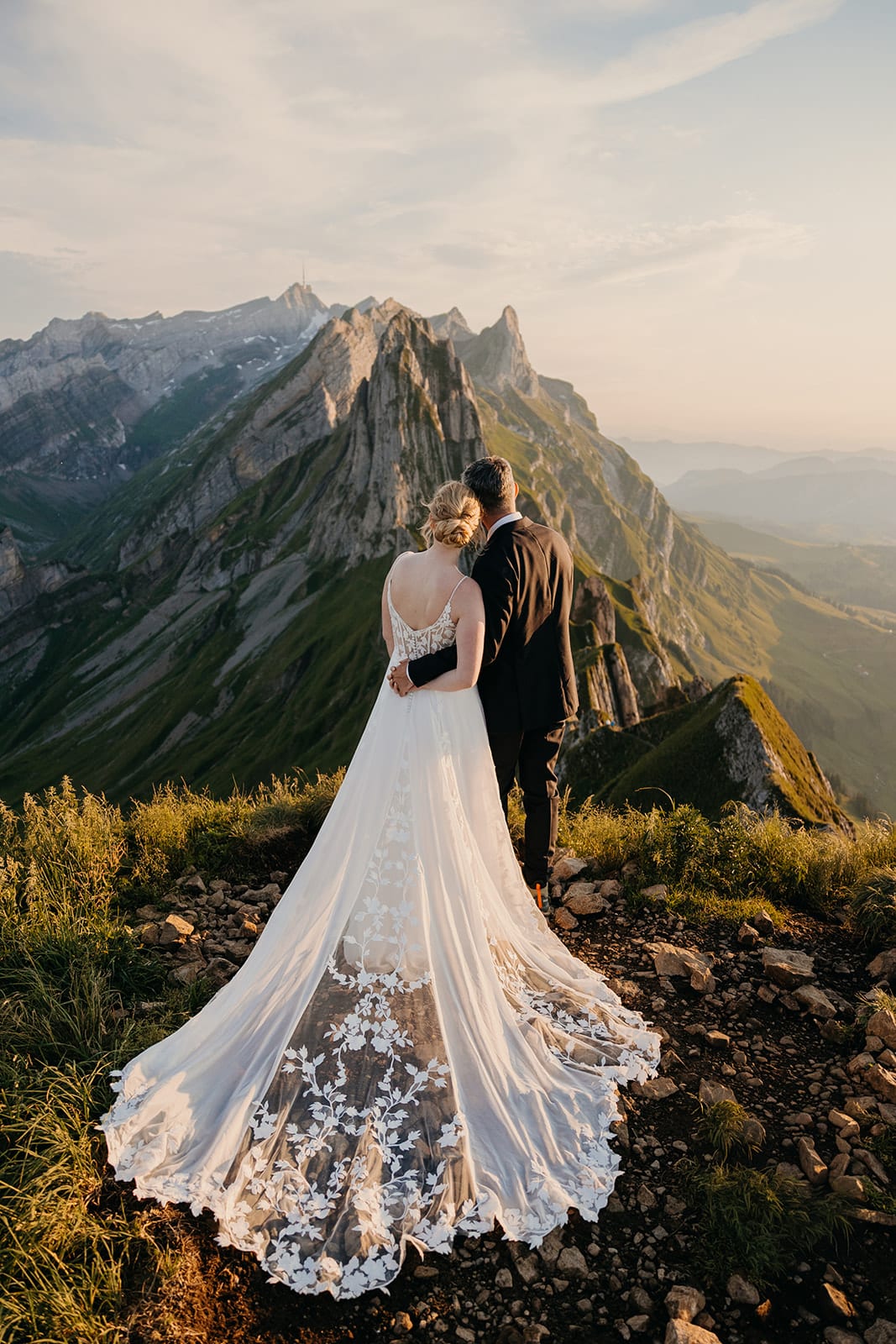 A bride and groom hold each other close, enjoying the views.