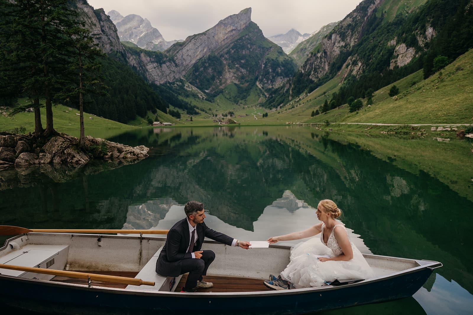 A bride hands her groom a letter from loved ones.