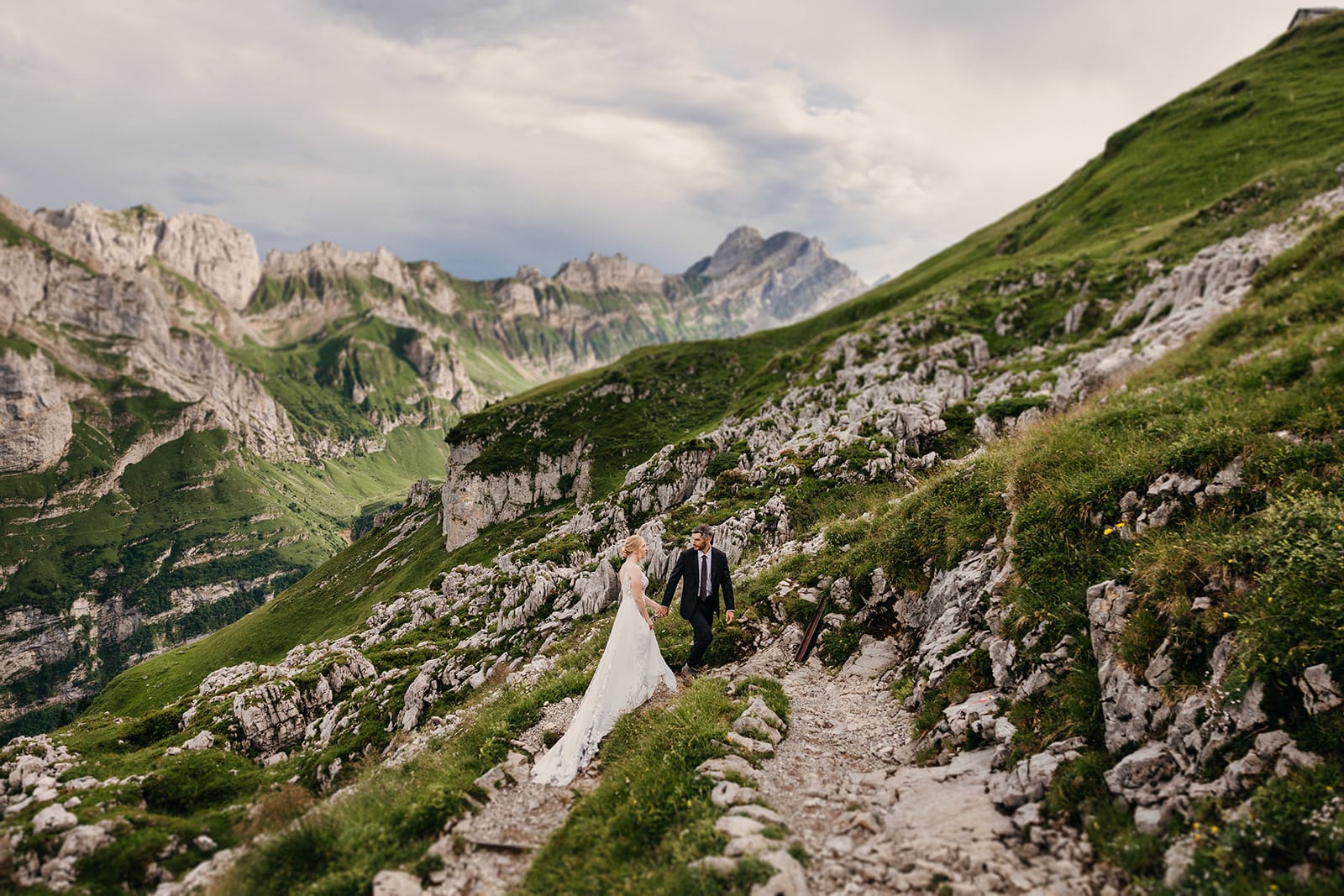 A groom leads his bride up the trail.