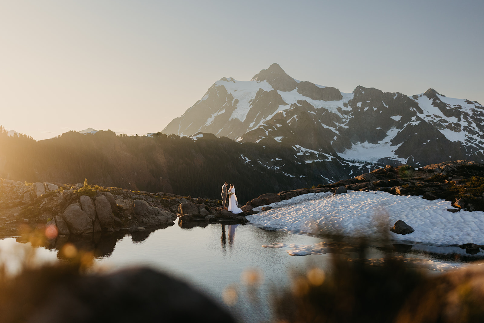 A couple stands together during sunrise at the iconic Artist Point in Washington.