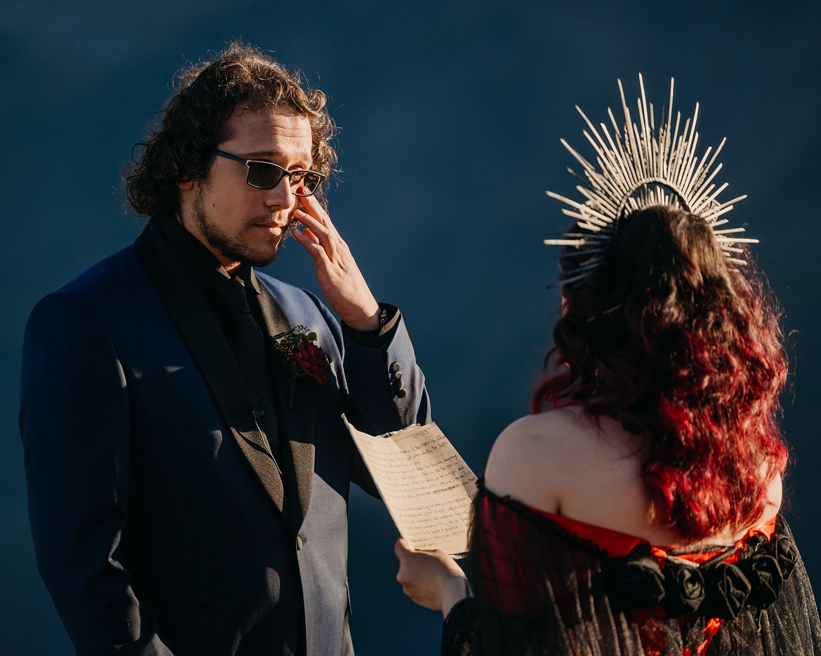A groom wipes his tears away as he listen's to his partners wedding vows.