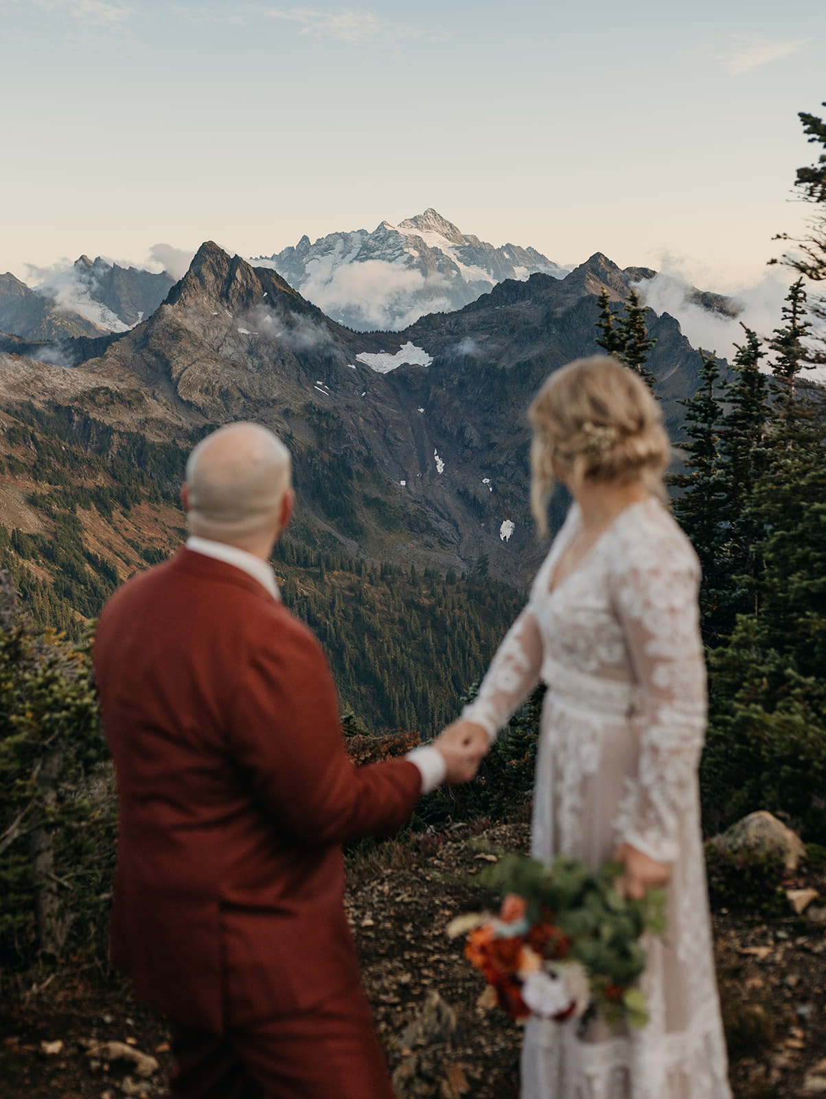 Bride and groom hold hands during their Winchester Mountain elopement.