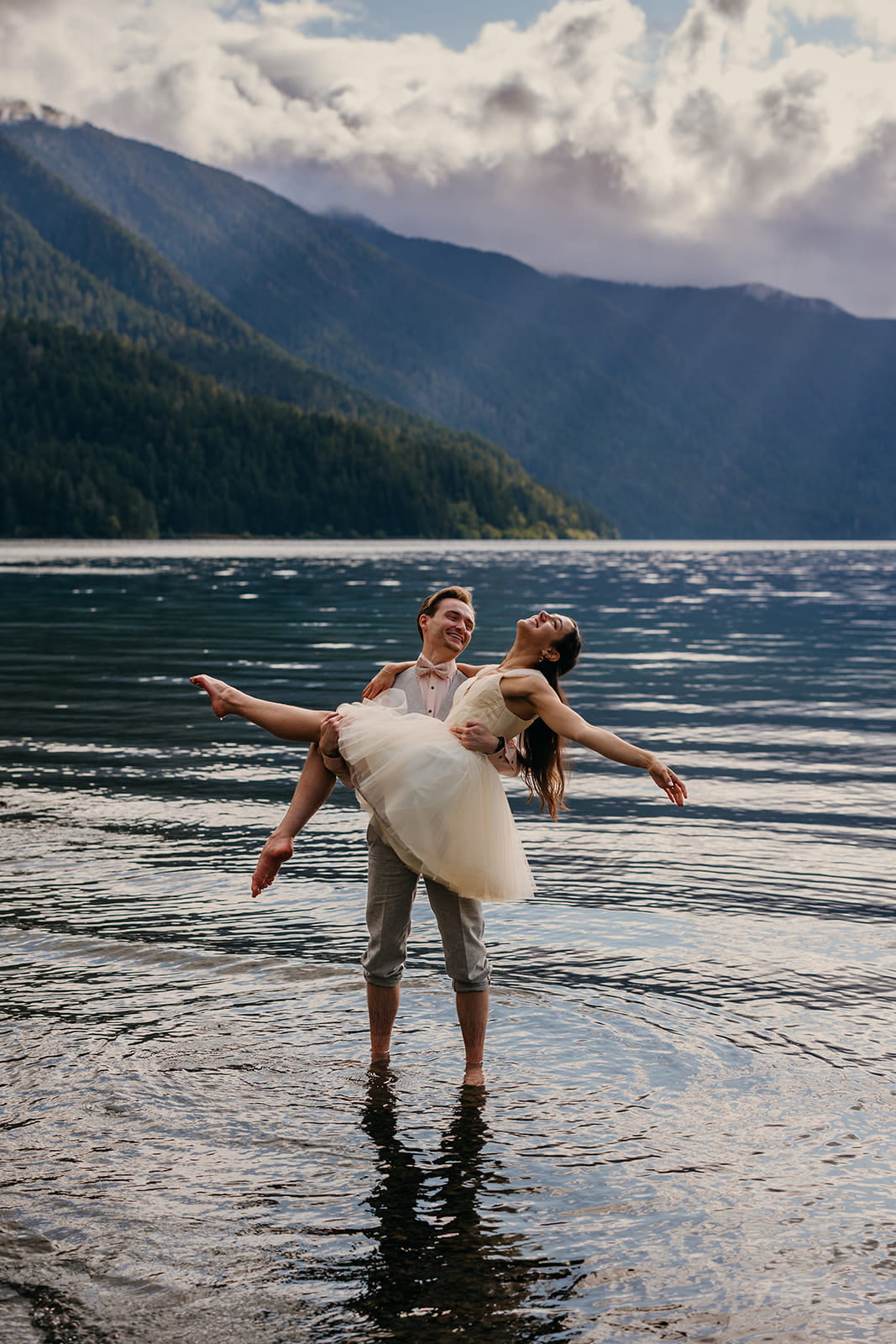 Newlyweds dance in Lake Crescent during their Port Angeles Wedding.
