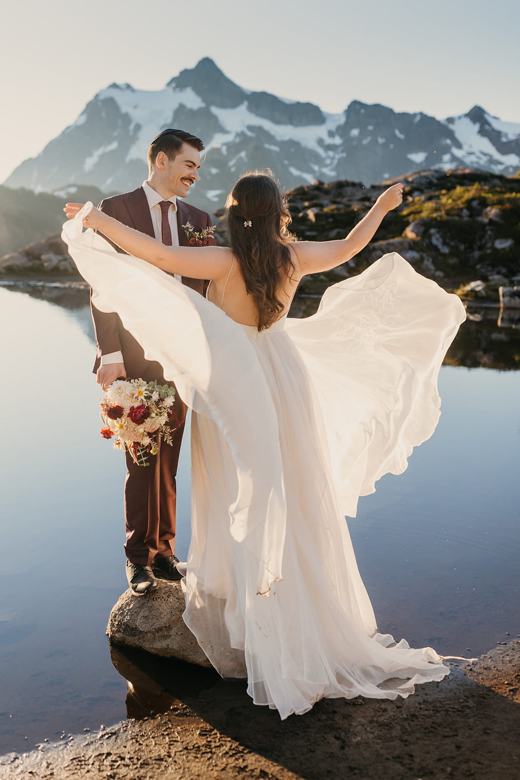 Bride plays with her flowing wedding dress during her Huntoon Point sunrise elopement.