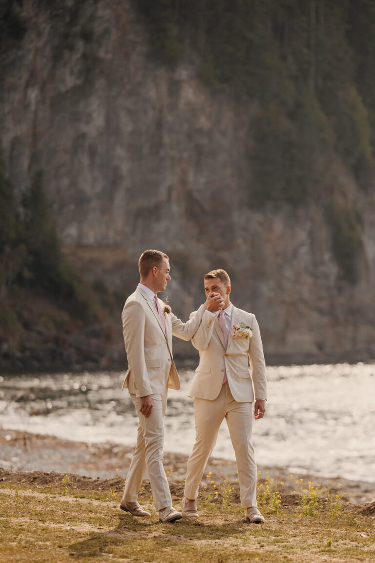 Two grooms wear cream elopement suits on the coast of Washington.